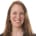 A photo of a smiling white woman with reddish hair